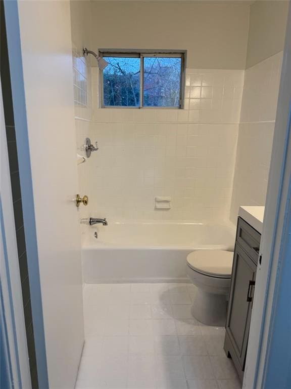 full bathroom featuring tile patterned floors, vanity, toilet, and tiled shower / bath