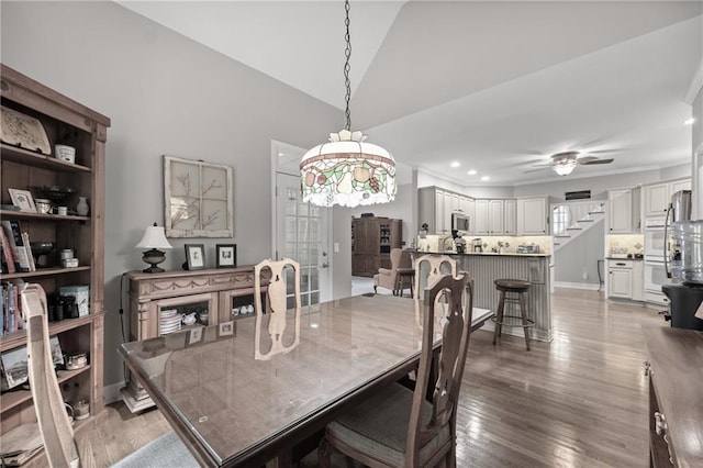 dining area with wood-type flooring, ceiling fan, and lofted ceiling