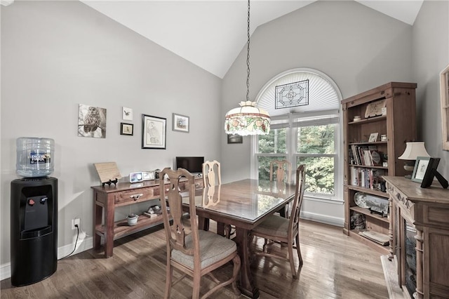 dining room featuring wood-type flooring and vaulted ceiling