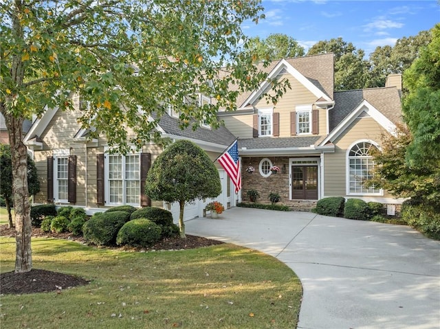 view of property with a front yard and a garage