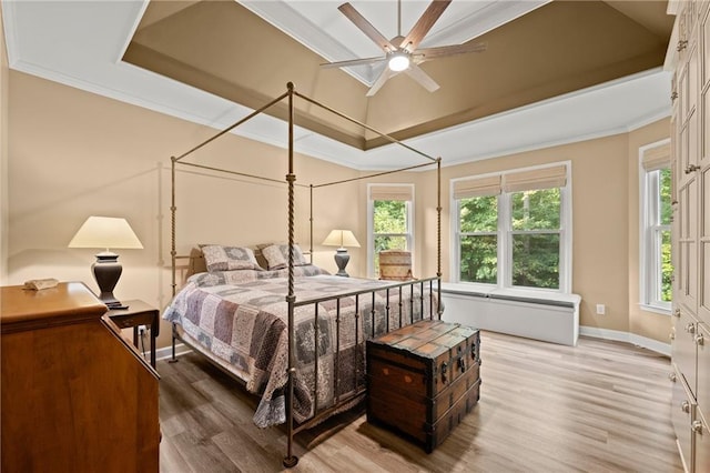 bedroom featuring ceiling fan, hardwood / wood-style floors, and crown molding