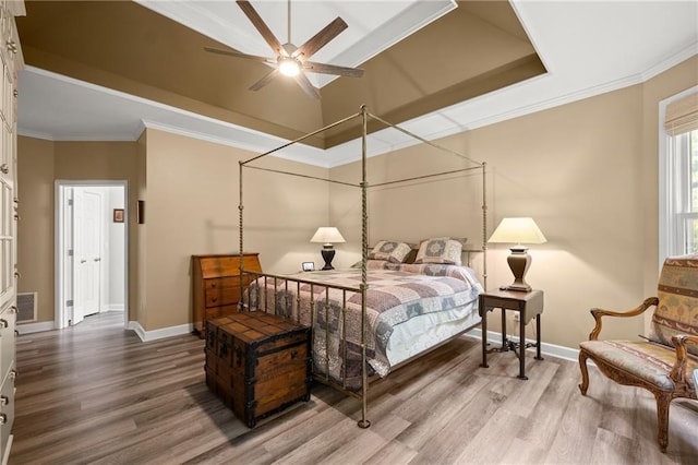 bedroom with ceiling fan, wood-type flooring, and crown molding