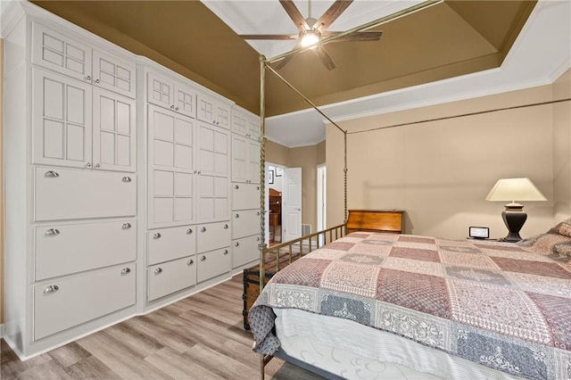 bedroom with ceiling fan, crown molding, and light hardwood / wood-style flooring