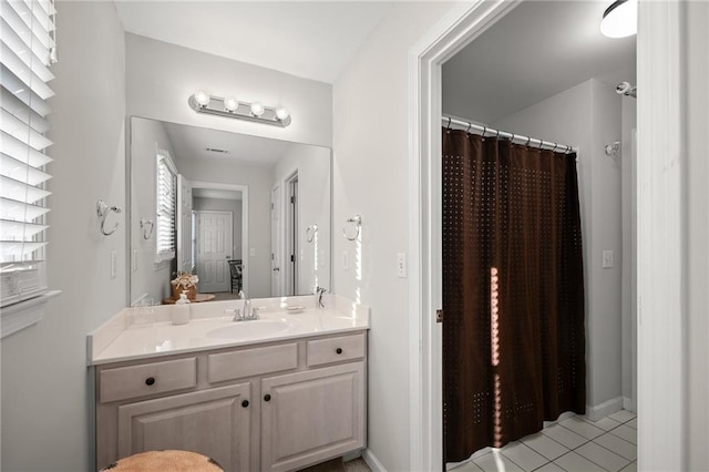 bathroom featuring vanity, tile patterned floors, and walk in shower