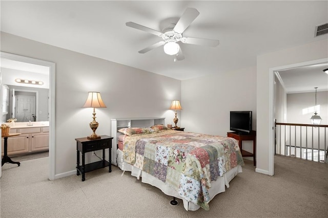 carpeted bedroom with ensuite bath, ceiling fan, and sink