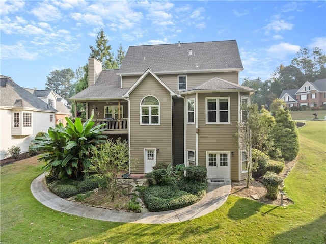 rear view of house with a lawn