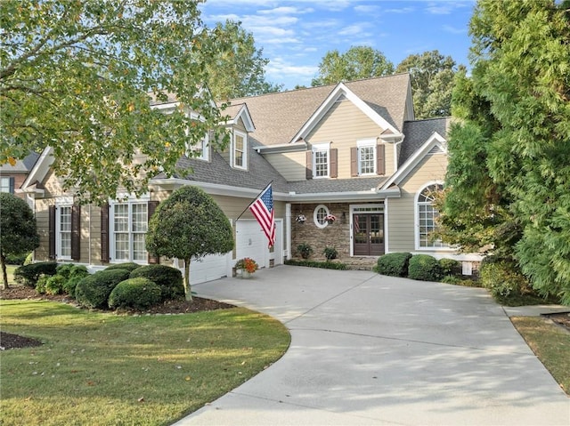 view of front of house featuring a front yard and a garage