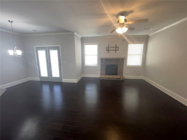 unfurnished living room with baseboards, a stone fireplace, dark wood finished floors, and crown molding