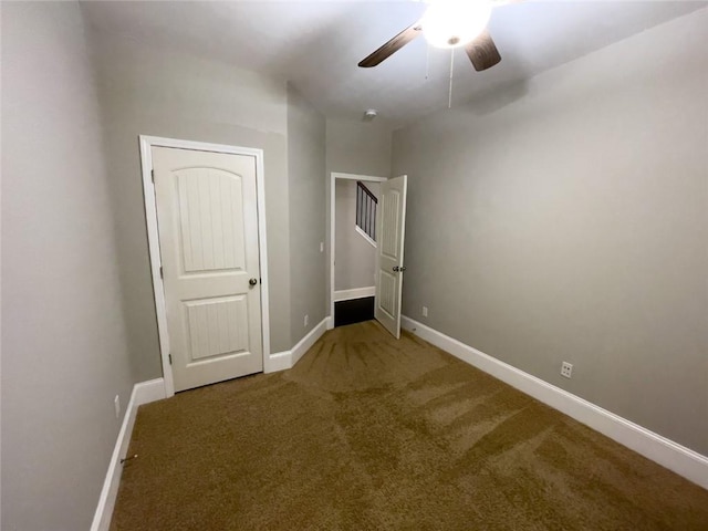 unfurnished bedroom with baseboards, ceiling fan, and carpet flooring