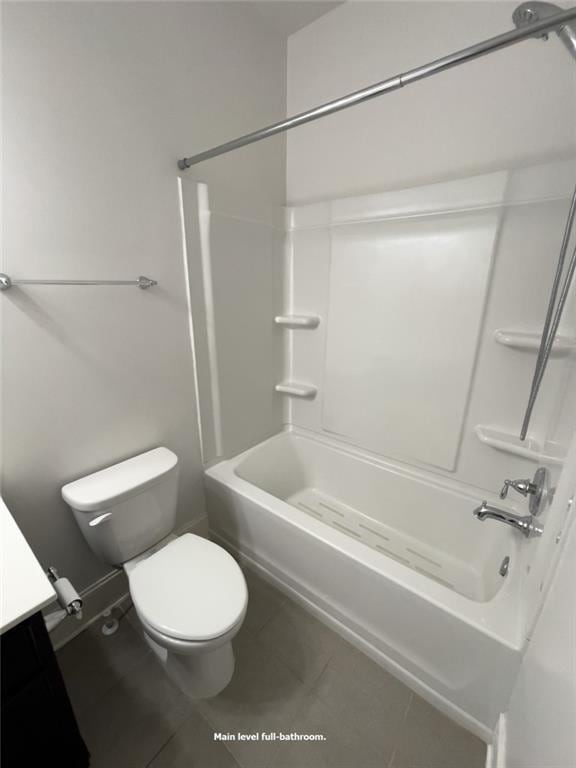 full bath featuring tub / shower combination, toilet, vanity, and tile patterned flooring