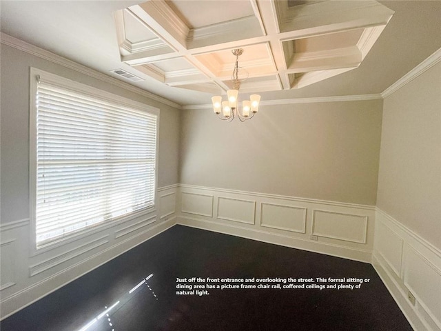 unfurnished dining area featuring visible vents, a notable chandelier, a wainscoted wall, and coffered ceiling