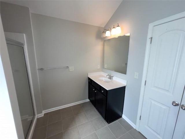 full bath featuring vanity, baseboards, tile patterned flooring, vaulted ceiling, and a shower stall