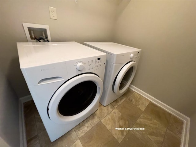 clothes washing area featuring washer and dryer, laundry area, and baseboards