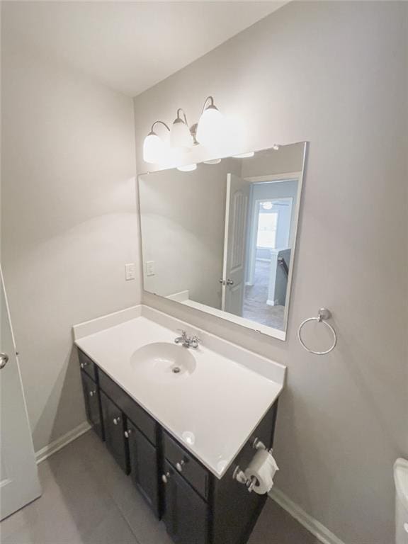 bathroom with baseboards and vanity