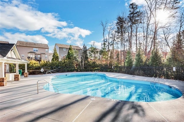 community pool featuring a patio area and fence