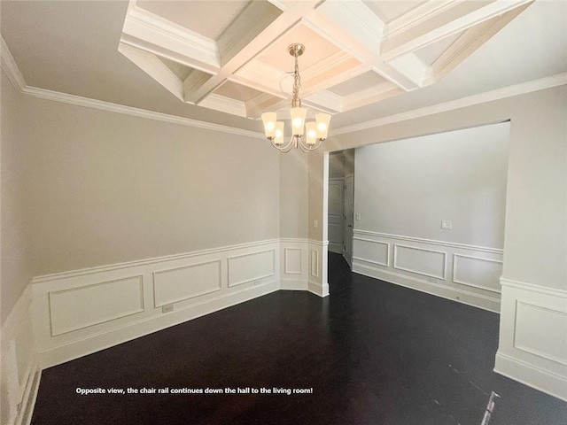 empty room featuring an inviting chandelier, coffered ceiling, and beam ceiling