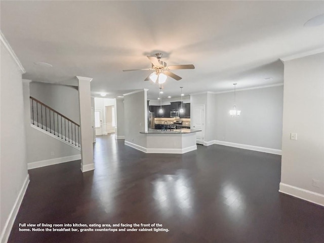 unfurnished living room with crown molding, baseboards, stairway, dark wood-style floors, and a ceiling fan