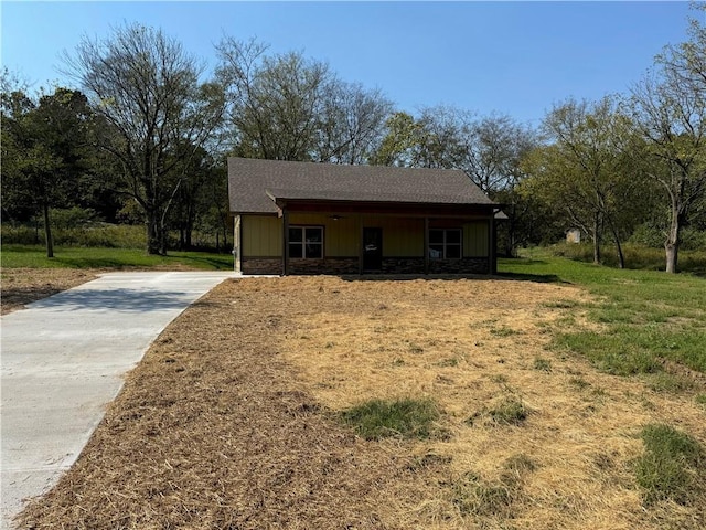 107 Church St SE, Ranger, GA 30734 - view of front facade featuring board and batten siding, a front yard, driveway, and stone siding
