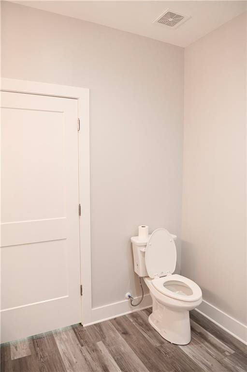 107 Church St SE, Ranger, GA 30734 - bathroom with baseboards, wood finished floors, visible vents, and toilet