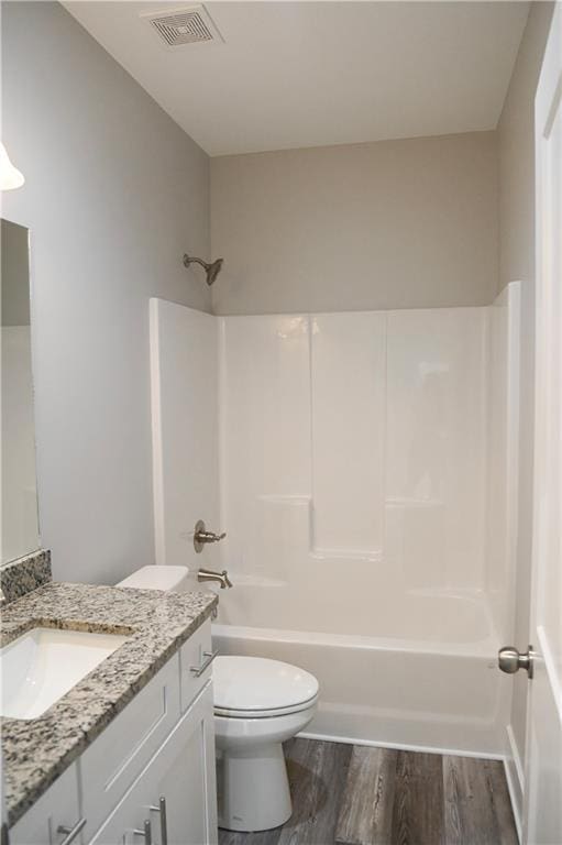 107 Church St SE, Ranger, GA 30734 - bathroom with vanity, toilet, bathing tub / shower combination, wood finished floors, and visible vents