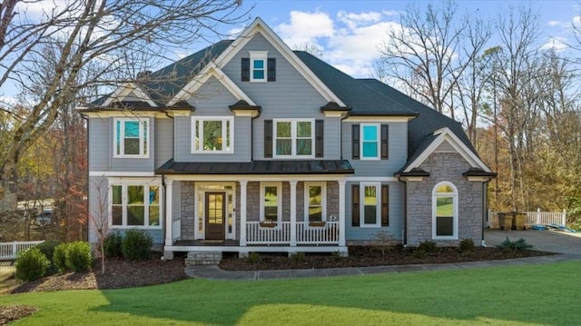 view of front of home with covered porch and a front yard