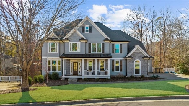 view of front of property with covered porch and a front lawn