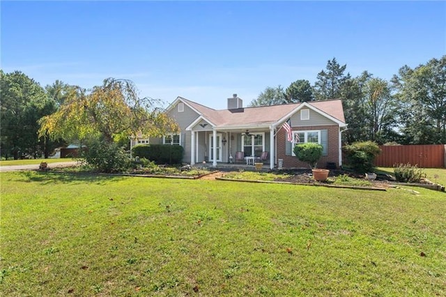 ranch-style house with covered porch and a front lawn