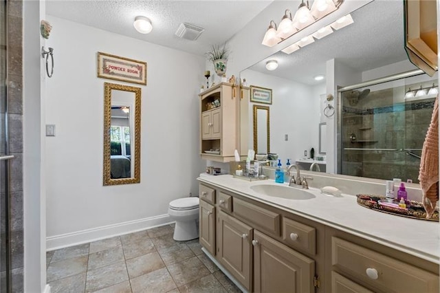 bathroom with a shower with door, vanity, a textured ceiling, and toilet