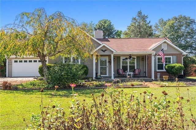 view of front facade featuring covered porch, a front yard, and a garage