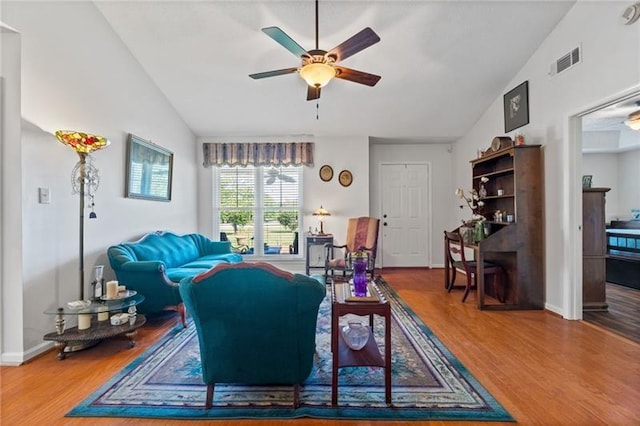 living room featuring hardwood / wood-style floors, ceiling fan, and lofted ceiling