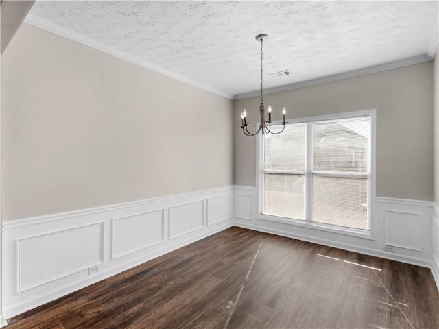 unfurnished dining area with crown molding, a textured ceiling, and a chandelier