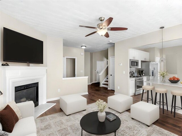 interior space with ceiling fan, sink, and a textured ceiling