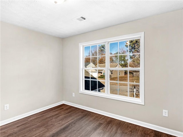 empty room featuring wood-type flooring