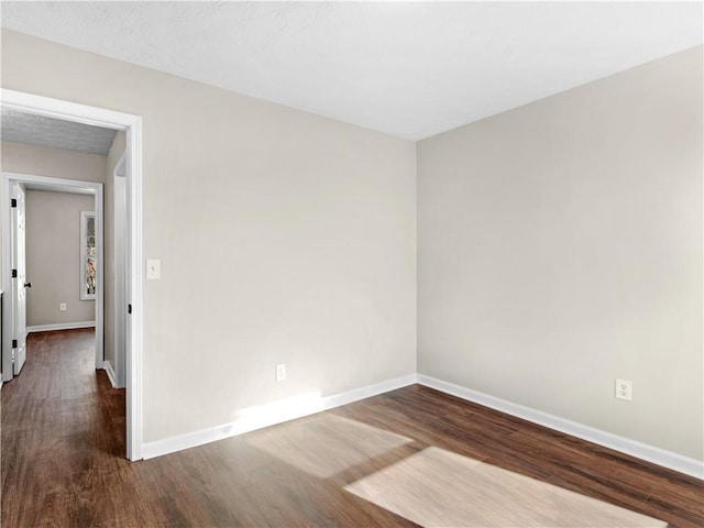 unfurnished room featuring dark hardwood / wood-style floors