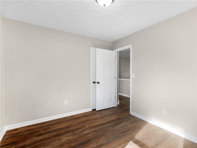 empty room with dark wood-type flooring