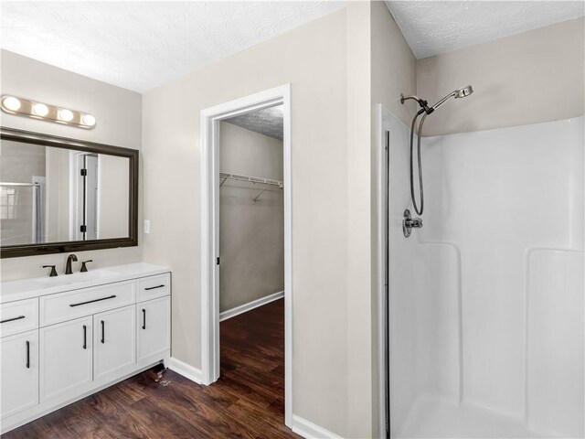 spare room featuring wood-type flooring, vaulted ceiling, and ceiling fan