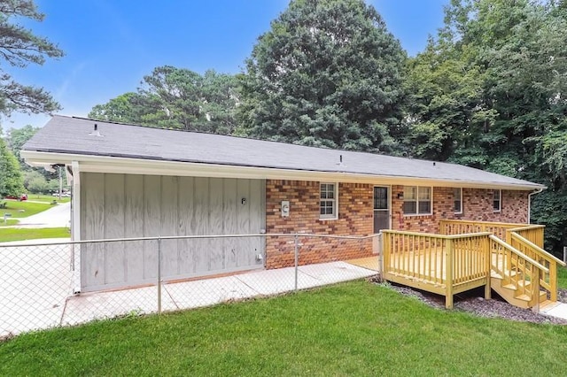 4820 Oak Grove Dr, Cumming, GA 30040 - rear view of house featuring a yard, a wooden deck, and brick siding