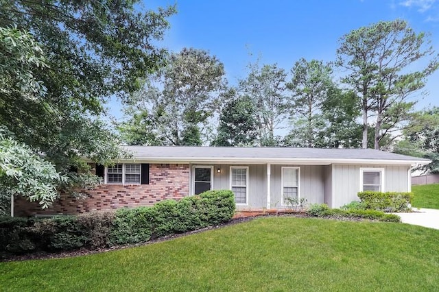4820 Oak Grove Dr, Cumming, GA 30040 - ranch-style house featuring a front lawn, brick siding, and covered porch