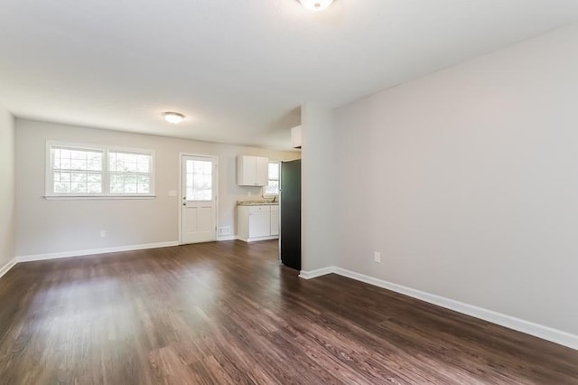4820 Oak Grove Dr, Cumming, GA 30040 - unfurnished living room featuring dark wood finished floors and baseboards