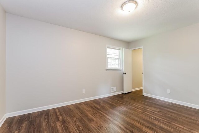 4820 Oak Grove Dr, Cumming, GA 30040 - spare room featuring dark wood finished floors and baseboards
