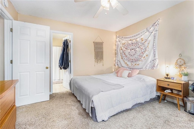 carpeted bedroom featuring a spacious closet and a ceiling fan