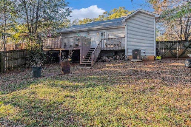 rear view of property with stairway, a fenced backyard, a deck, and central air condition unit