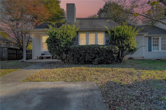 view of front of home with fence and a chimney