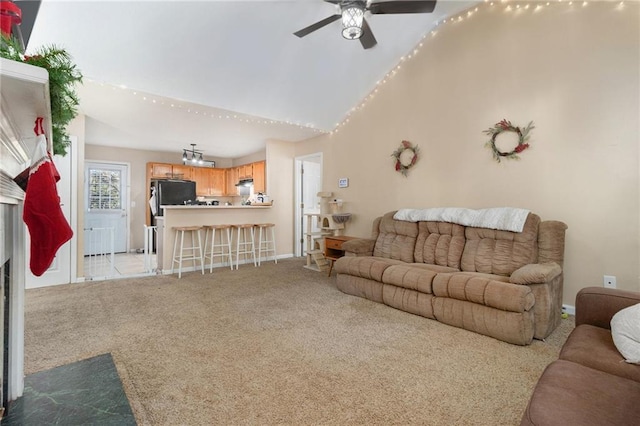 living room with light carpet, ceiling fan, high vaulted ceiling, and baseboards