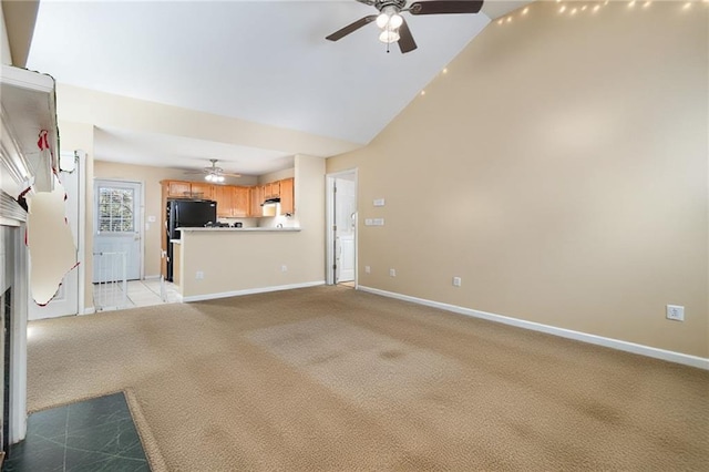 unfurnished living room with light carpet, baseboards, and a ceiling fan