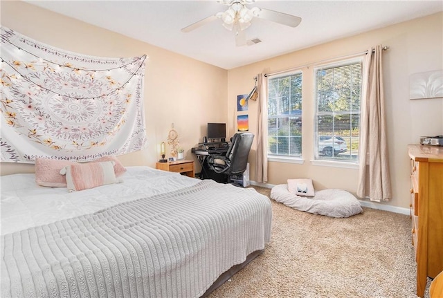 carpeted bedroom with visible vents, ceiling fan, and baseboards