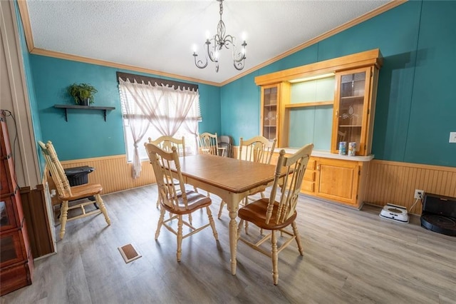 735 Hale Rd, Maysville, GA 30558 - dining room with a chandelier, wood finished floors, wainscoting, ornamental molding, and a textured ceiling