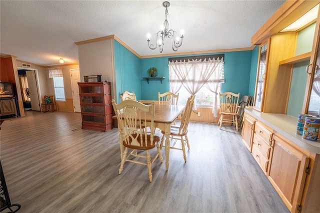 735 Hale Rd, Maysville, GA 30558 - dining room featuring wood finished floors, ornamental molding, a textured ceiling, and a chandelier