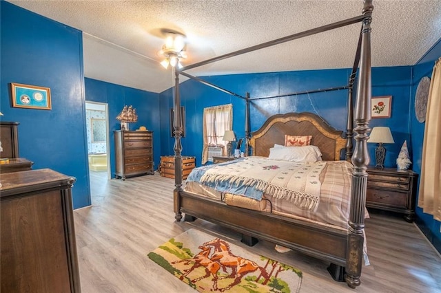735 Hale Rd, Maysville, GA 30558 - bedroom with a textured ceiling, wood finished floors, and ensuite bath