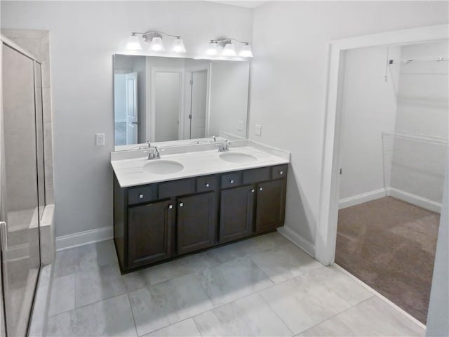 bathroom with tile patterned floors, walk in shower, and vanity